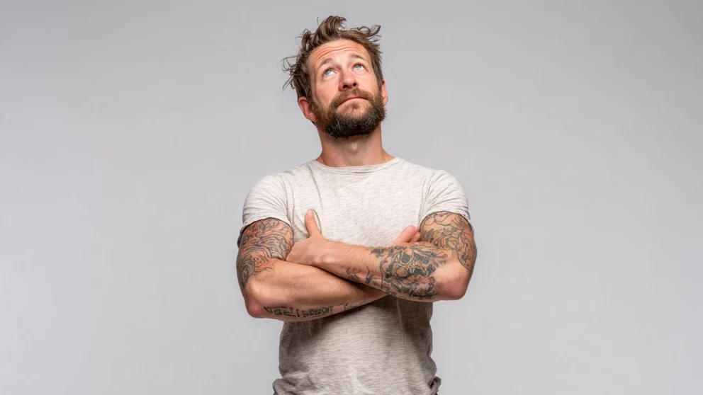 Muscle man with gray shirt and tattoo