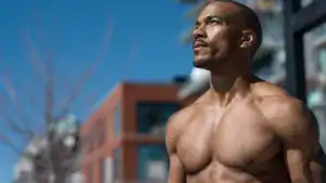 a fit middle aged shirtless man outside