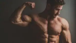 A man flexing his muscles in the studio