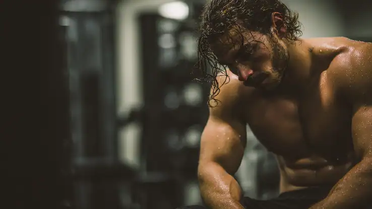A man taking a breather from working out