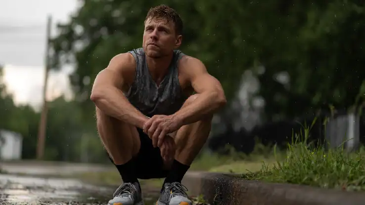 man taking a rest while running outdoors
